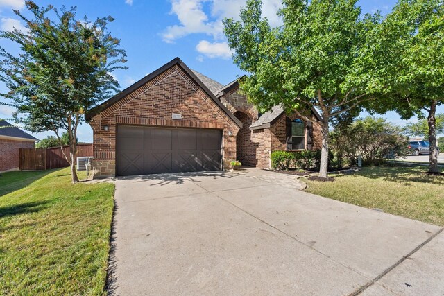 view of front property featuring a garage and a front lawn