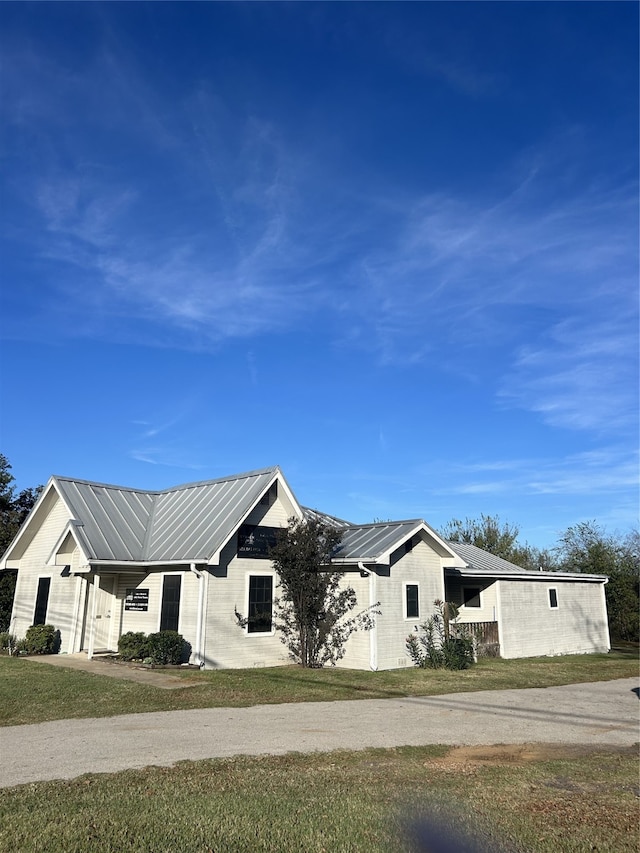 view of side of home featuring a lawn