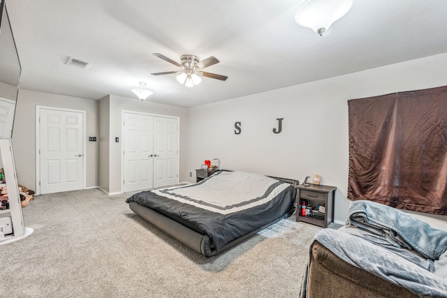 bedroom with ceiling fan and light colored carpet