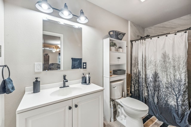 bathroom featuring a shower with curtain, vanity, and toilet