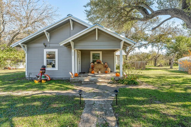 bungalow-style house featuring a front yard