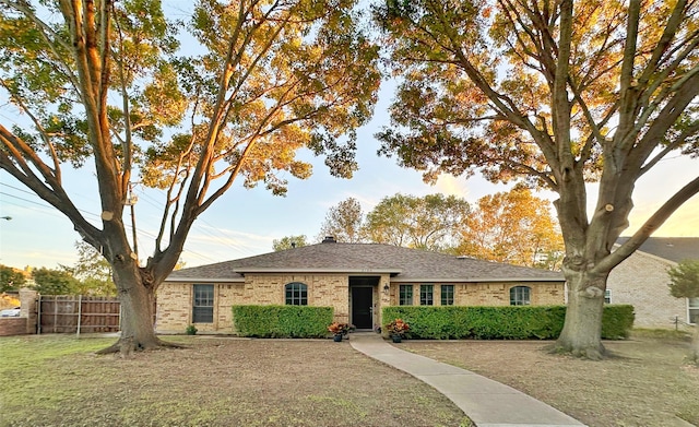 ranch-style house featuring a front lawn