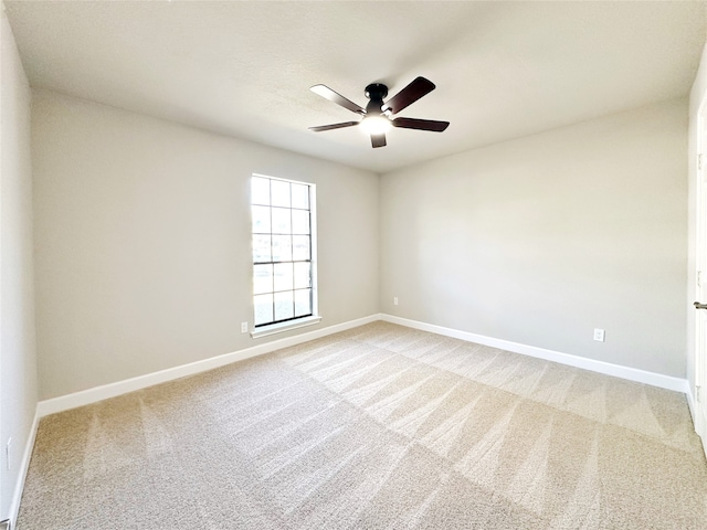 empty room featuring carpet and ceiling fan