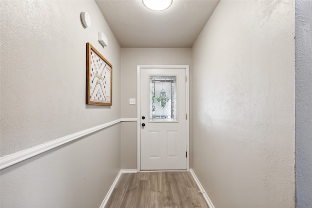 doorway with hardwood / wood-style floors