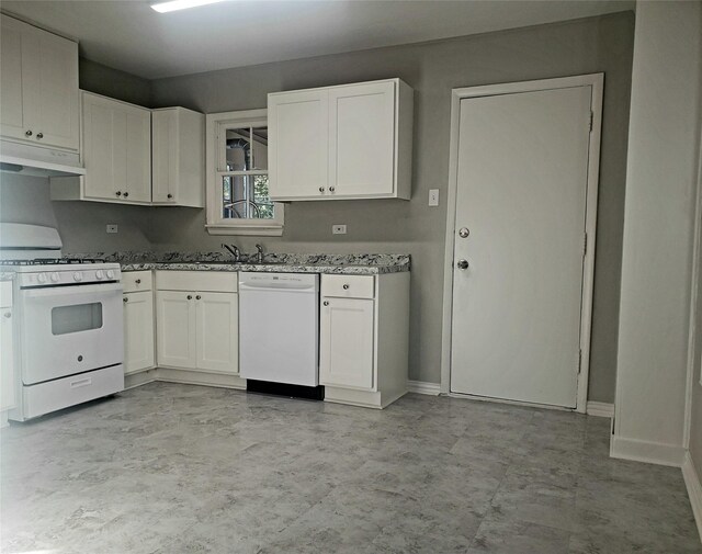 kitchen with white cabinetry, light stone countertops, white appliances, and sink