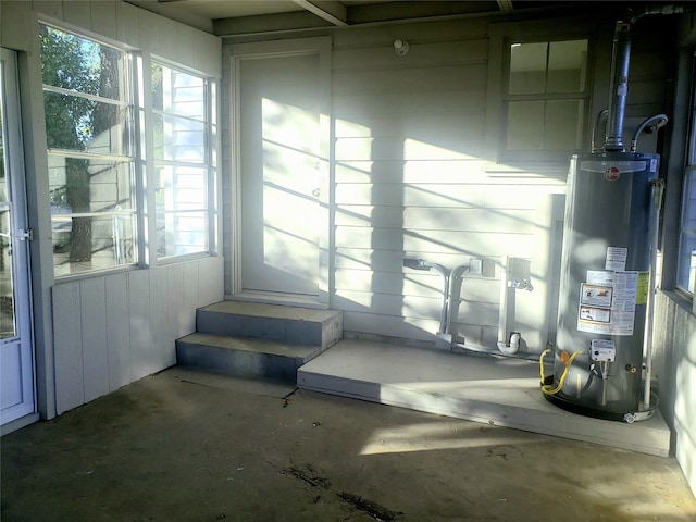 sunroom / solarium featuring a wealth of natural light and water heater