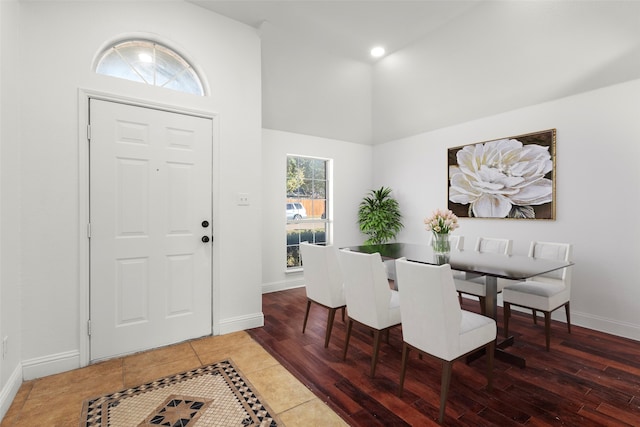 dining area featuring dark hardwood / wood-style floors and high vaulted ceiling