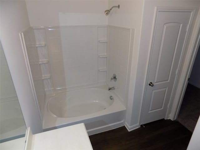 bathroom featuring washtub / shower combination and hardwood / wood-style floors