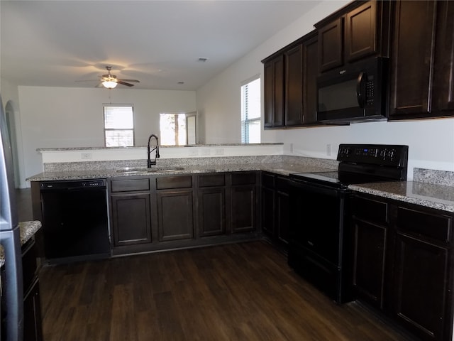 kitchen with sink, plenty of natural light, dark wood-type flooring, and black appliances