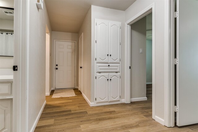 hall with light hardwood / wood-style floors