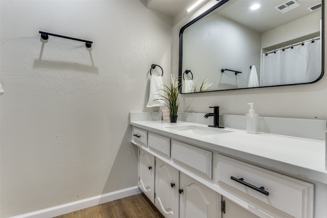 bathroom with hardwood / wood-style floors and vanity