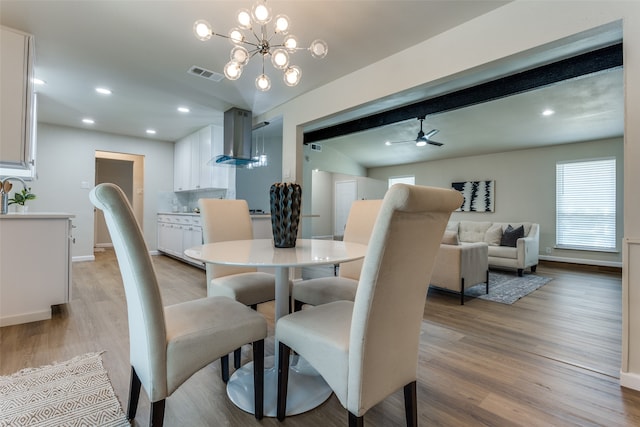 dining room featuring light hardwood / wood-style floors and ceiling fan with notable chandelier