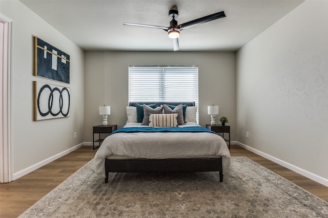 bedroom with dark hardwood / wood-style floors and ceiling fan