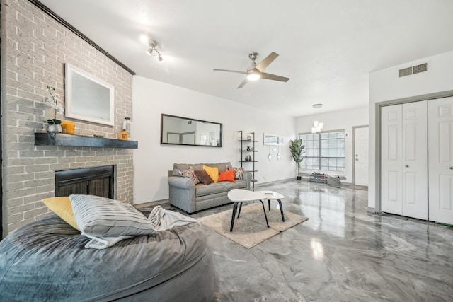 living room with concrete flooring, ceiling fan with notable chandelier, and a brick fireplace