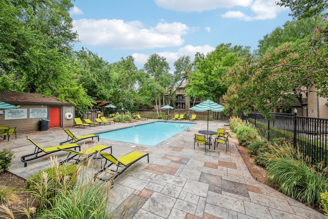 view of pool featuring a patio area and an outbuilding