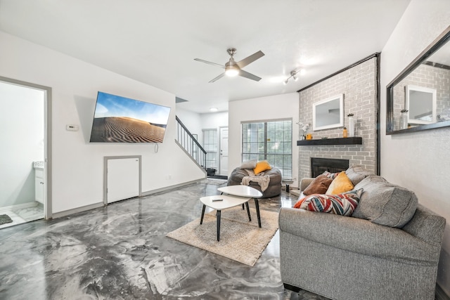 living room with concrete flooring, a brick fireplace, and ceiling fan