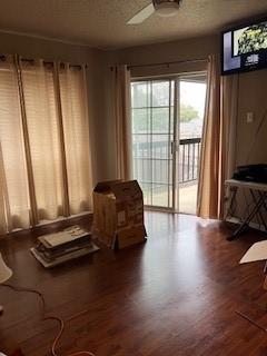 sitting room with ceiling fan, a textured ceiling, and hardwood / wood-style flooring