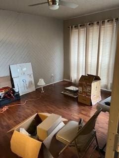 living area featuring wood-type flooring and ceiling fan