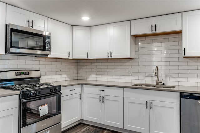 kitchen featuring white cabinets, sink, and stainless steel appliances