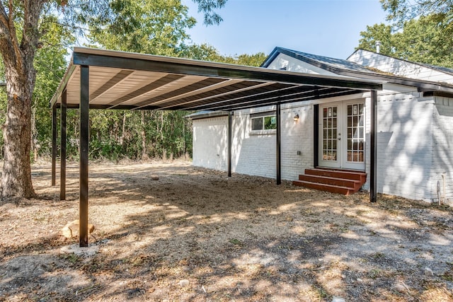 exterior space with french doors and a carport