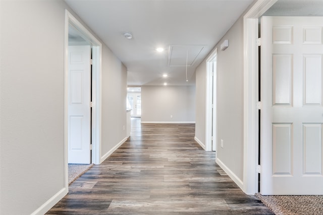 corridor with dark hardwood / wood-style flooring