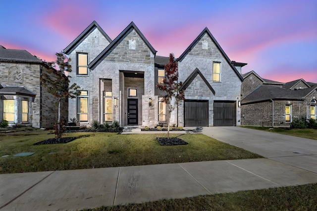 view of front of house featuring a lawn and a garage