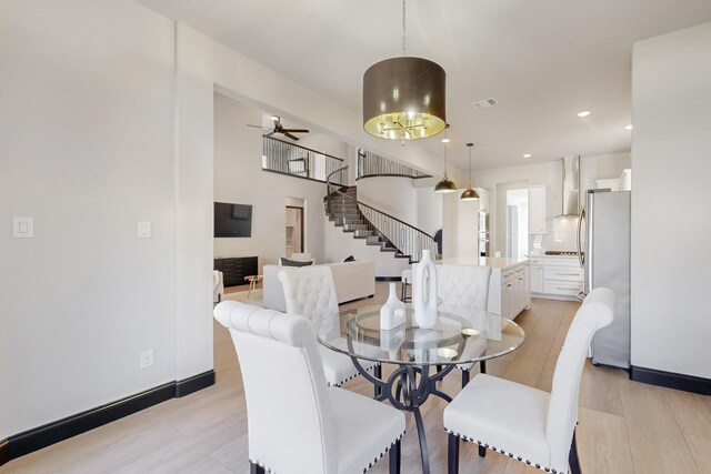 dining room featuring ceiling fan and light hardwood / wood-style flooring