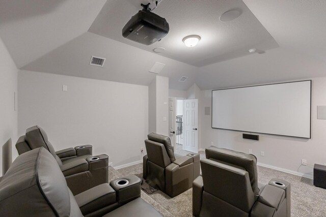 home theater room with lofted ceiling and carpet floors