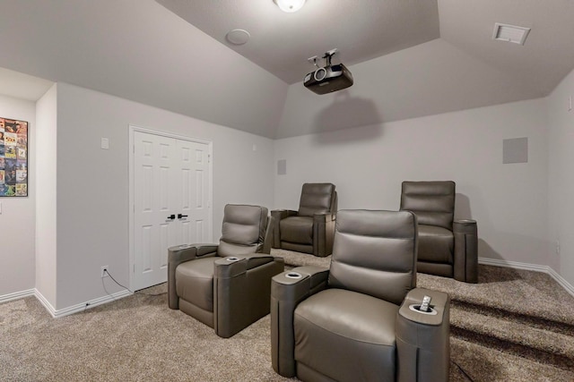 cinema with light carpet and vaulted ceiling