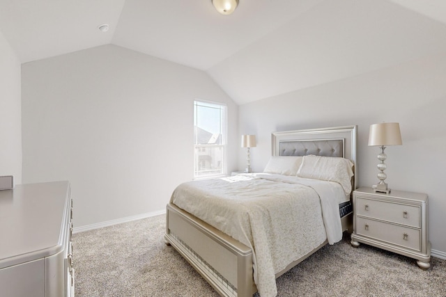 carpeted bedroom with lofted ceiling