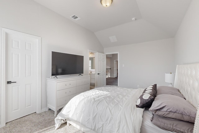 bedroom featuring lofted ceiling and light carpet