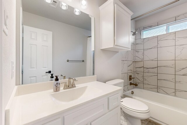 full bathroom featuring vanity, toilet, and tiled shower / bath