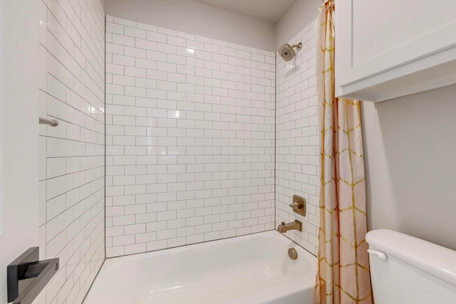 bathroom featuring shower / bath combination with curtain and toilet