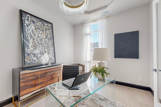 office area featuring hardwood / wood-style floors and an inviting chandelier