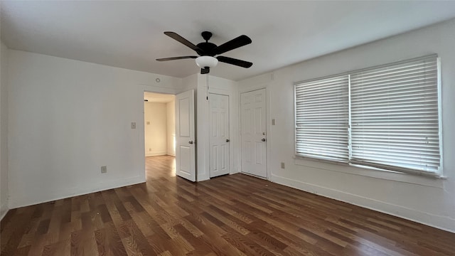 unfurnished bedroom with ceiling fan and dark hardwood / wood-style flooring