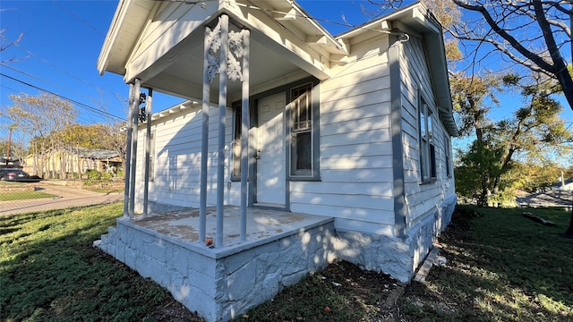 view of side of home featuring a yard