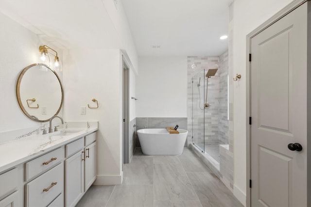 bathroom with vanity and separate shower and tub