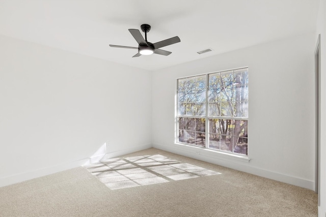 carpeted spare room with ceiling fan