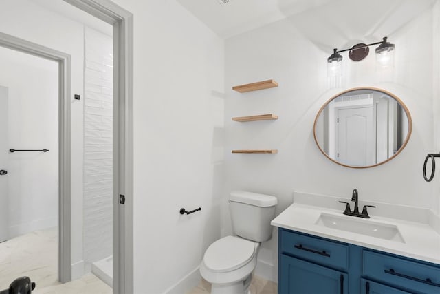 bathroom with vanity, toilet, and walk in shower