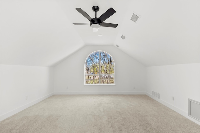 additional living space with lofted ceiling, light colored carpet, and ceiling fan