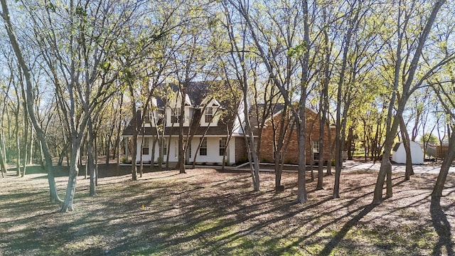 view of front of house featuring a storage unit