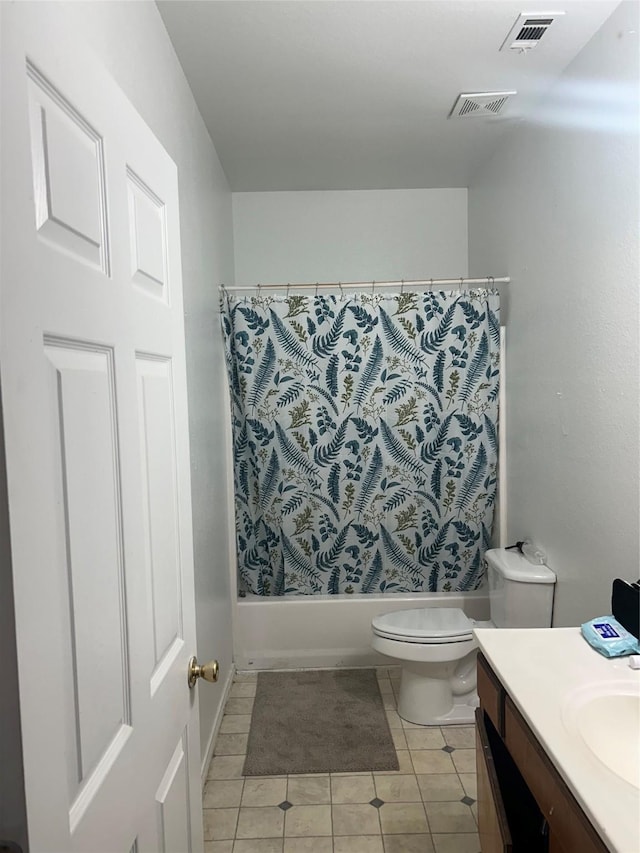 full bathroom with tile patterned floors, shower / tub combo with curtain, vanity, and toilet