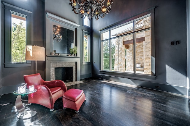 living area featuring dark hardwood / wood-style floors, an inviting chandelier, and a wealth of natural light