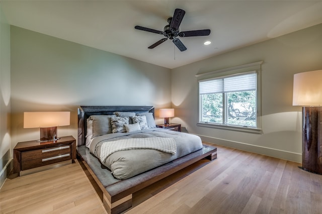 bedroom featuring ceiling fan and light hardwood / wood-style flooring