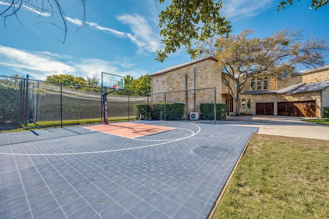 view of basketball court with a yard