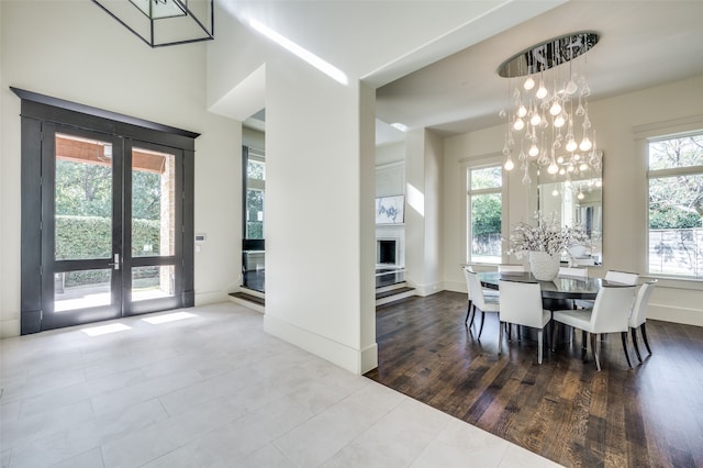 dining space featuring hardwood / wood-style floors, french doors, and a healthy amount of sunlight