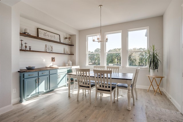 dining space with a chandelier, light wood-type flooring, and plenty of natural light