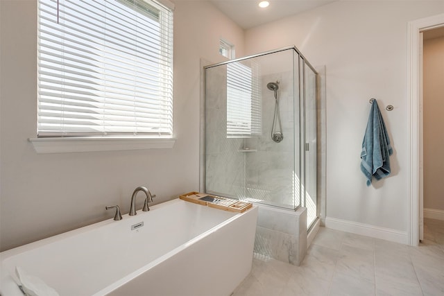 bathroom with separate shower and tub and a healthy amount of sunlight