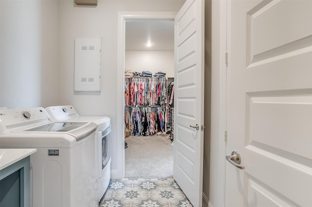 clothes washing area featuring light colored carpet, separate washer and dryer, and electric panel