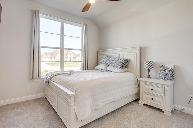 carpeted bedroom with ceiling fan, lofted ceiling, and multiple windows